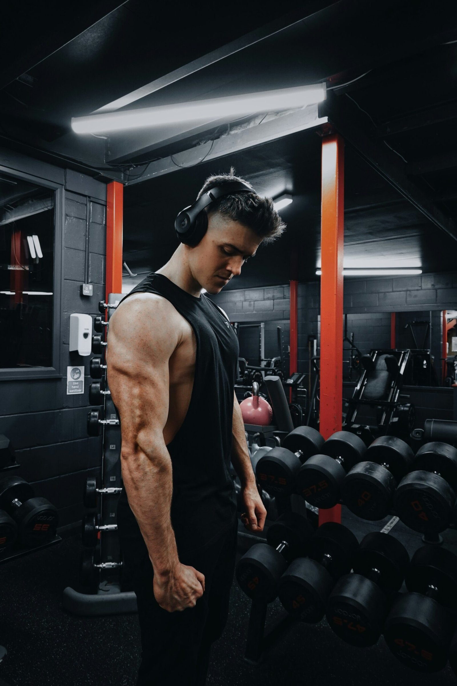 man in black tank top wearing black headphones